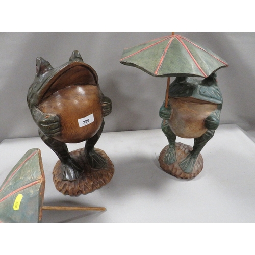 286 - Two novelty carved figures of frogs with umbrellas A/F