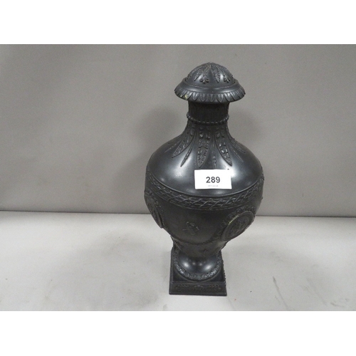 289 - A Wedgwood black Basalt lidded urn - lid damaged with typical classical vignettes and musical instru... 