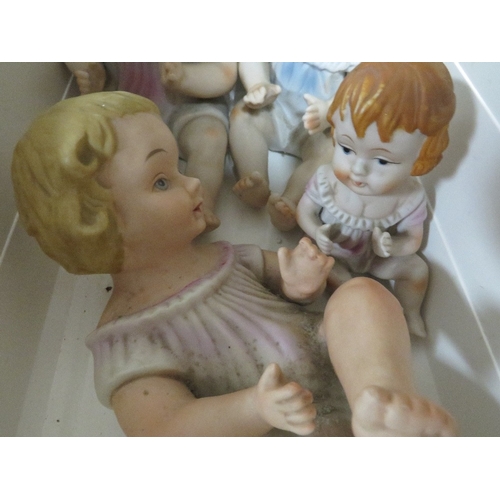 297 - Four vintage porcelain baby figures