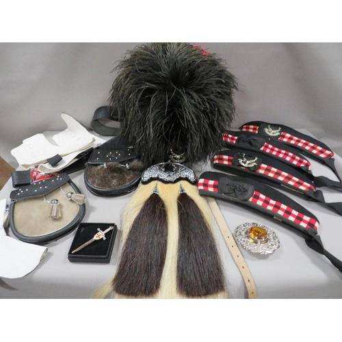 299 - A feather bonnet together with a tray containing a new horsehair sporran, sealskin sporran, pair of ... 