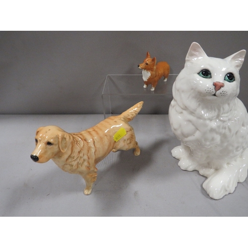 334 - A large Beswick seated cat in white together with a Golden Labrador and a Corgi