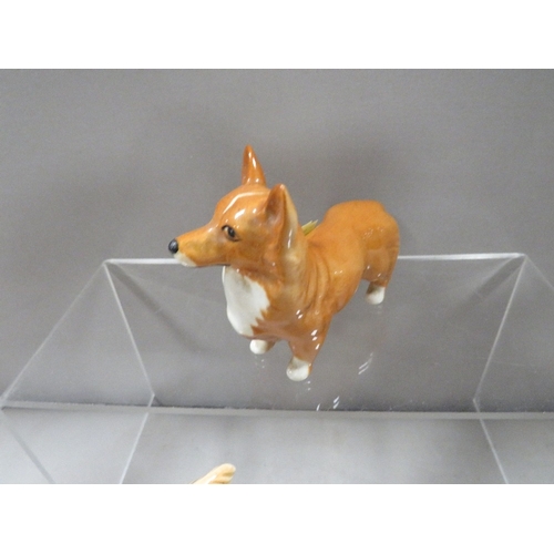 334 - A large Beswick seated cat in white together with a Golden Labrador and a Corgi