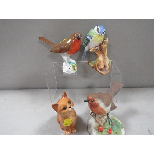 336 - A Royal Doulton seated Ginger cat together with three assorted bird figures one A/F