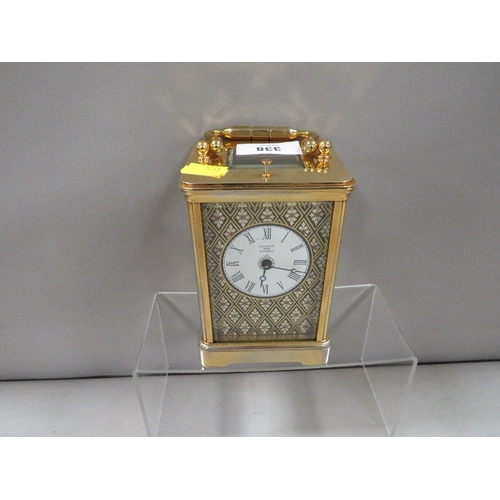 338 - A Halcyon Days enamelled decorated carriage clock with key