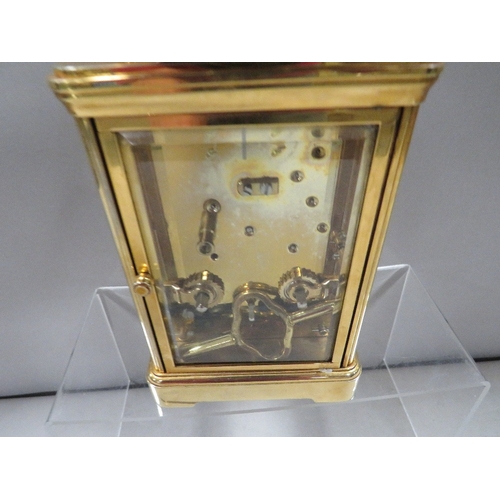 338 - A Halcyon Days enamelled decorated carriage clock with key