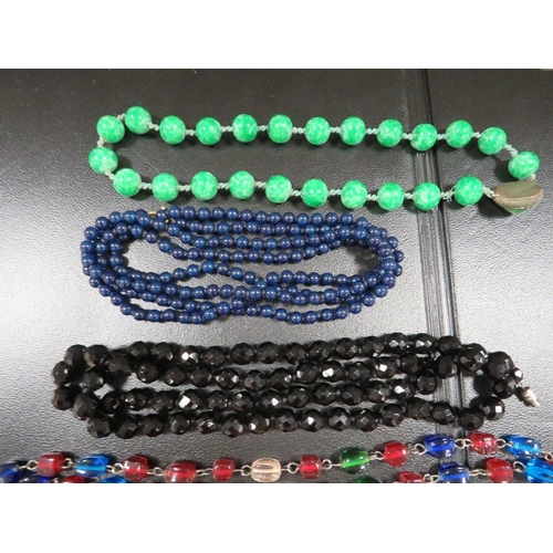 395 - A quantity of antique bead necklaces, including jade types