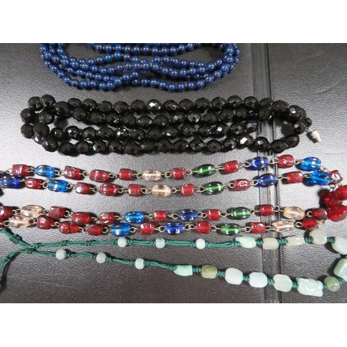 395 - A quantity of antique bead necklaces, including jade types