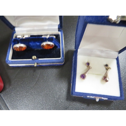 396 - A quantity of boxed silver jewellery, to include an amber set, cufflinks and marcasite cameo earring... 