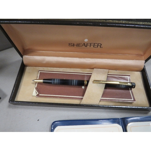 416 - A tray of collectable coins together with two boxed Sheaffe pens