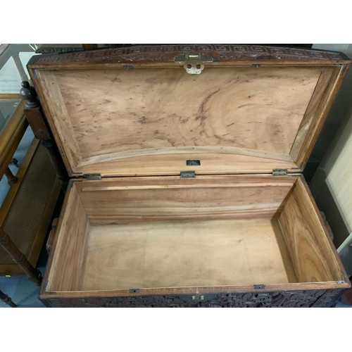 702 - A large Eastern carved camphor wood domed chest W 105 cm