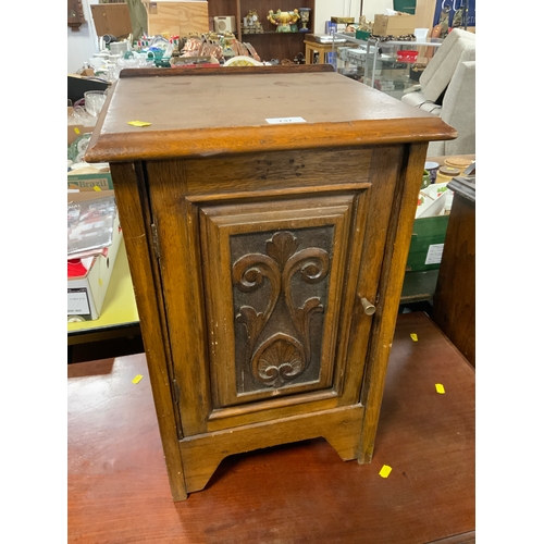 737 - A small carved oak bedside cupboard