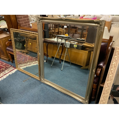 751 - A large modern framed silver mirror 129 x 106 cm, together with a smaller gilt mirror and a black fr... 