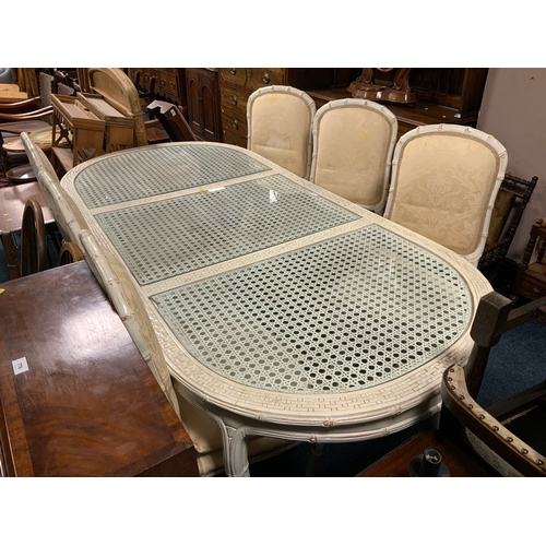 775 - A vintage faux bamboo table with inset glass top and six chairs - Table L 218 cm