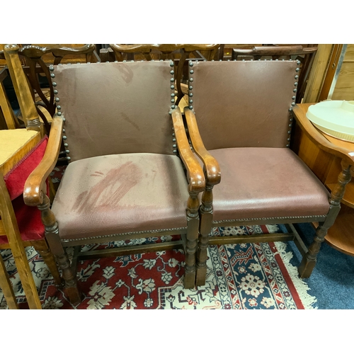 783 - A pair of heavy oak leather studded armchairs