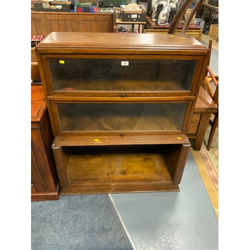 795 - A vintage oak glazed sectional bookcase W 90 cm together with a teak coffee table. (2)