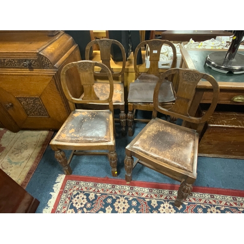 803 - A set of four carved oak dining chairs. S/D