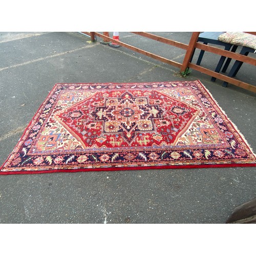 736 - A large woollen rug 312 x 202 cm