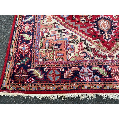 736 - A large woollen rug 312 x 202 cm