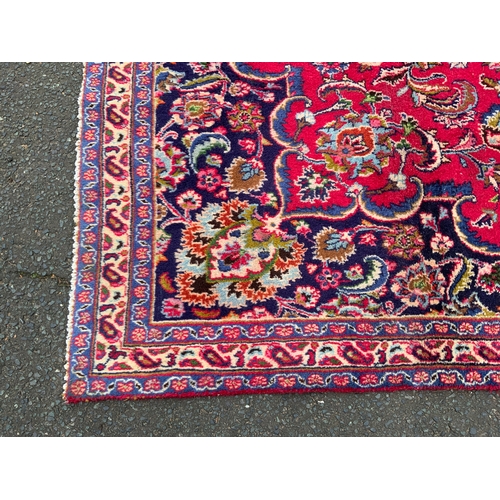 829 - A large Eastern woollen rug 307 x 220 cm