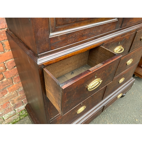 831 - A Georgian mahogany cupboard on chest with an arrangement of nine drawers H 185 cm W 123 cm