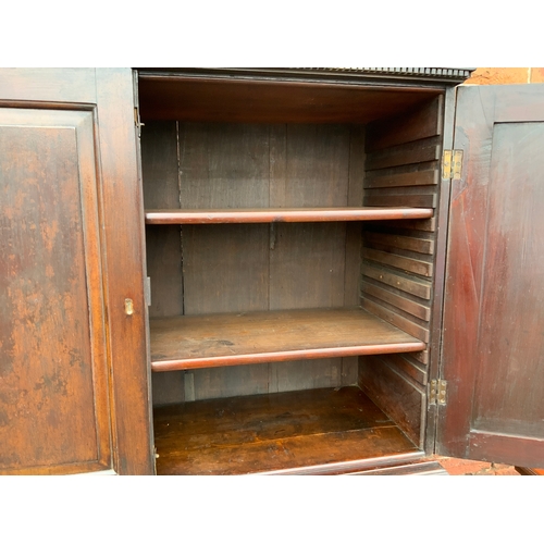 831 - A Georgian mahogany cupboard on chest with an arrangement of nine drawers H 185 cm W 123 cm