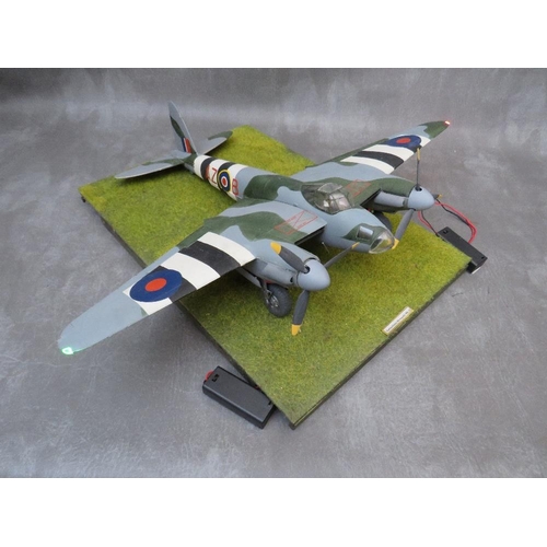 204 - A model of a DeHavilland Mosquito Mk4 on display stand, with working propellors and wing lights, win... 