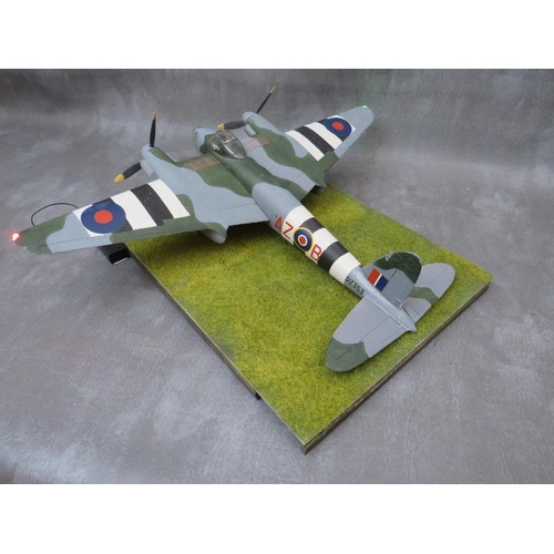 204 - A model of a DeHavilland Mosquito Mk4 on display stand, with working propellors and wing lights, win... 