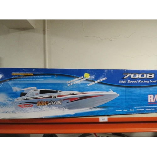 205 - A radio controlled 7008 hi-speed racing boat - untested, together with an Aston Martin remote contro... 