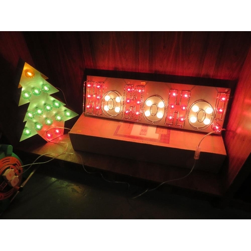 304 - A boxed new old stock HoHoHo! illuminated Christmas sign together with a similar illuminated Christm... 