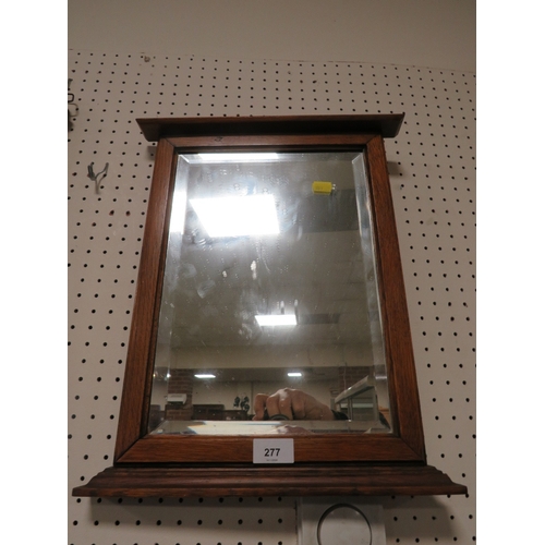 277 - A oak framed bevelled edged wall mirror