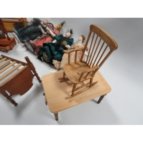 282 - A small collection of miniature dolls and dolls house furniture