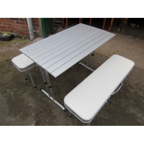 594 - A lightweight foldaway aluminium camping / dining set table and benches