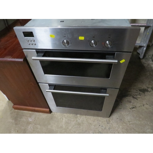 612 - An electric stainless steel larder mounted double oven