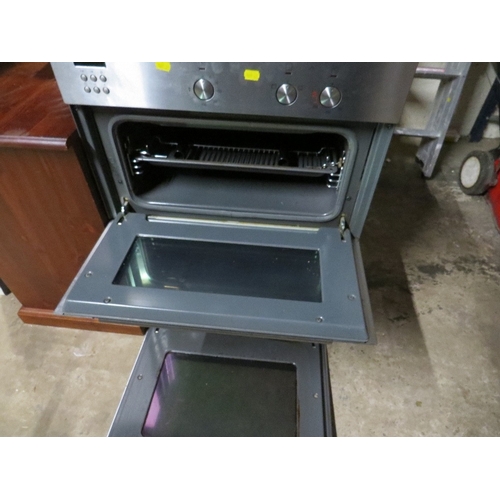 612 - An electric stainless steel larder mounted double oven