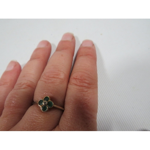 428 - A hallmarked 9 carat gold ring set with emeralds in a four leaf clover setting approx. weight 1.5g