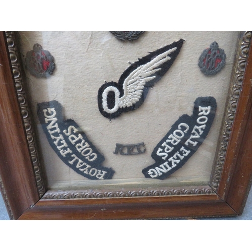 193 - A ROYAL FLYING CORPS BADGE COLLECTION IN FRAME, to include shoulder titles, cap and collar badges an... 