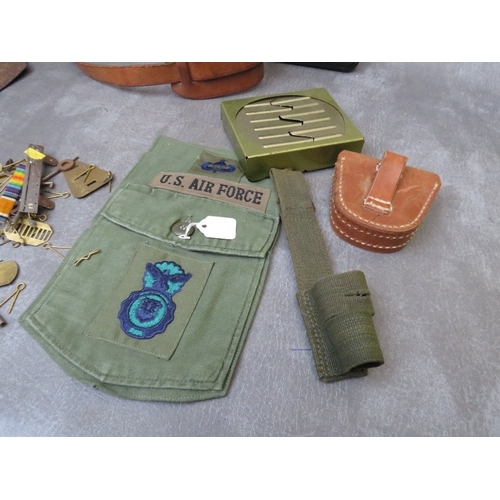 216 - A SMALL BOX OF MILITARY COLLECTABLES, to include cycle lamps, Swedish mag case, various pouches etc.