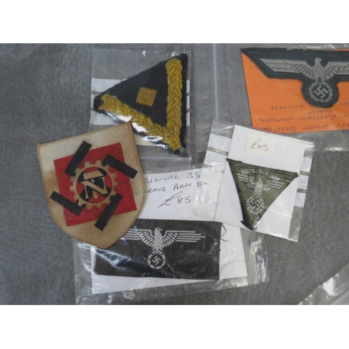 276 - A COLLECITON OF WW2 GERMAN CLOTH BADGES, including army side cap badges, Kriegsmarine chevron, breas... 