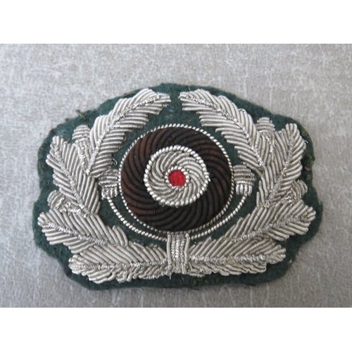 280 - A WW2 GERMAN BULLION BREAST EAGLE, and a bullion hat cockade (2) on dark green ground