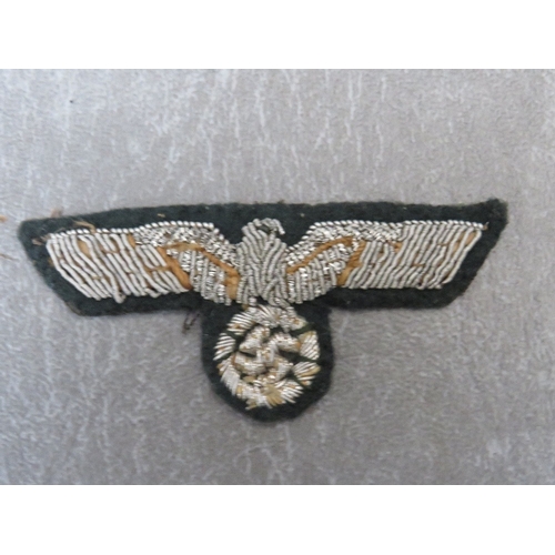 280 - A WW2 GERMAN BULLION BREAST EAGLE, and a bullion hat cockade (2) on dark green ground