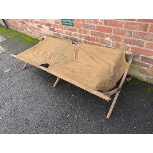 355 - A MILITARY FOLDING CAMP BED, of wood and canvas construction