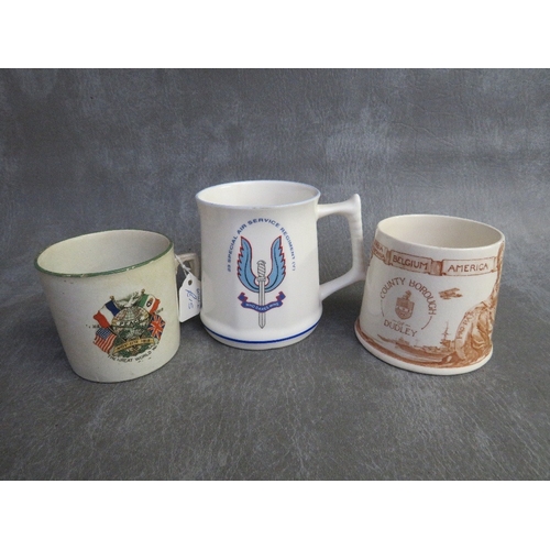 317 - A BOX OF MILITARY INTEREST CERAMICS, to include a cannon teapot, a Dudley peace mug 1919 and a Beden... 