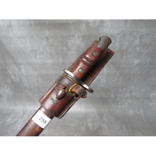 259 - A REMINGTON 1913 BAYONET, with issue mark 3 17, with wooden grooved grip, in scabbard with leather f... 