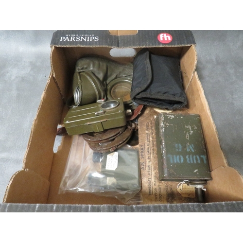 315 - A BOX OF MILITARY INTEREST COLLECTIBLES, to include a gas mask, a Vickers machine gun oil bottle, mo... 