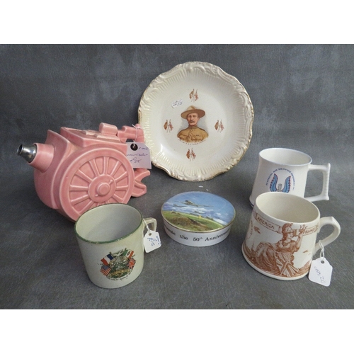 317 - A BOX OF MILITARY INTEREST CERAMICS, to include a cannon teapot, a Dudley peace mug 1919 and a Beden... 