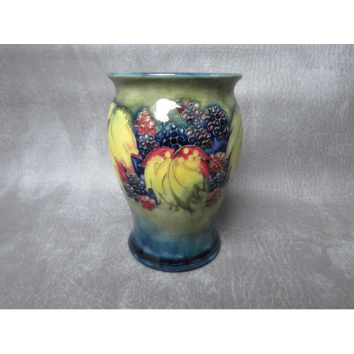 966 - A MOORCROFT LEAF AND BERRY PATTERN BALUSTER VASE, impressed marks and sticker to the base, H 13 cm