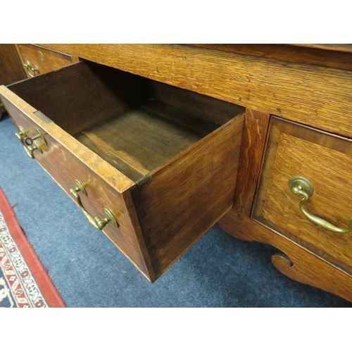 1177 - A 19TH CENTURY OAK COUNTRY DRESSER, having an enclosed plate rack with two crossbanded cupboards, ab... 