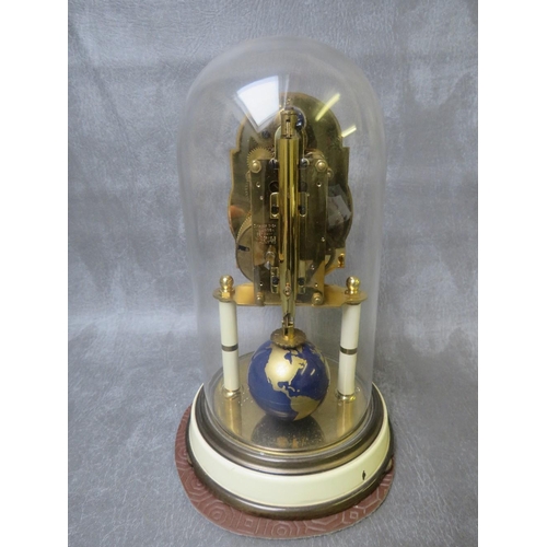 1145 - A 400 DAY KAISER UNIVERSE CLOCK WITH GLASS DOME, having a world globe rotating pendulum and upper mo... 