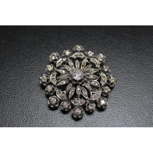 641 - A DIAMOND ENCRUSTED PENDANT BROOCH, set with a central diamond of an estimated 1.07 carats, which is... 