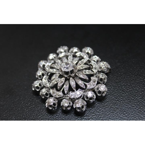 641 - A DIAMOND ENCRUSTED PENDANT BROOCH, set with a central diamond of an estimated 1.07 carats, which is... 